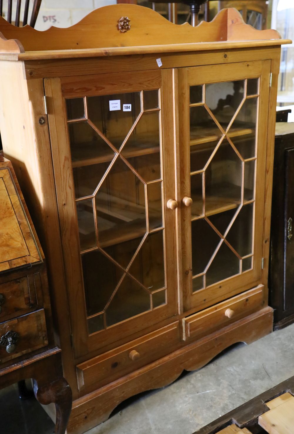 A glazed pine two door bookcase, width 112cm depth 26m height 150cm